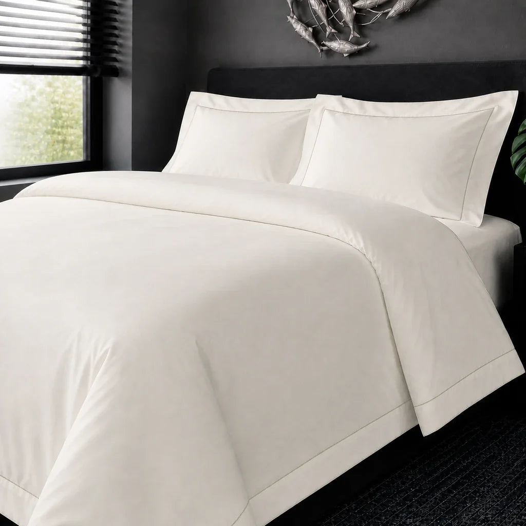 Cream cotton 200TC Oxford duvet cover set with stone one-row satin stitch – on-bed view | Linen & Co