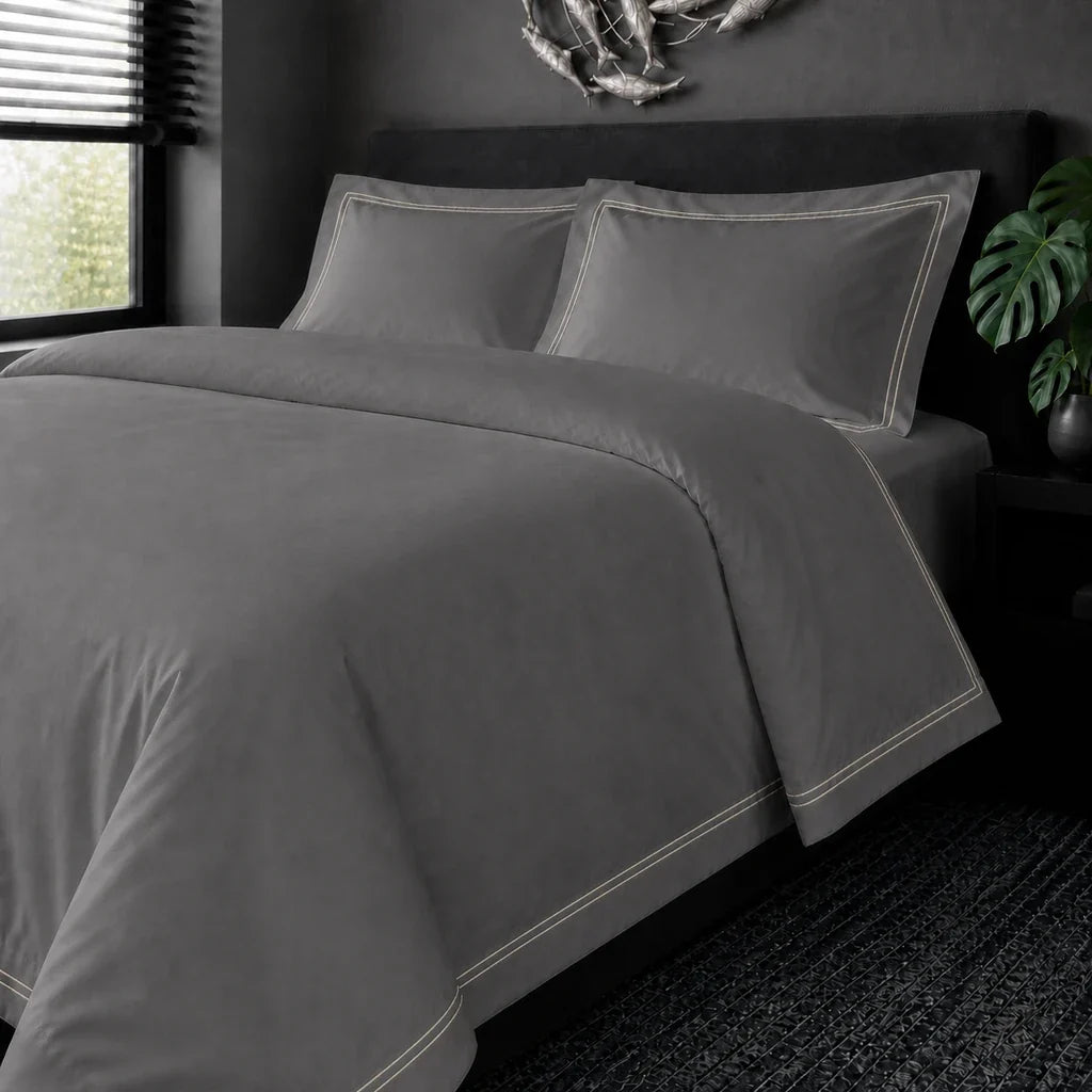 Grey cotton 200TC Oxford duvet cover set with cream two-row satin stitch – on the bed view | Linen & Co