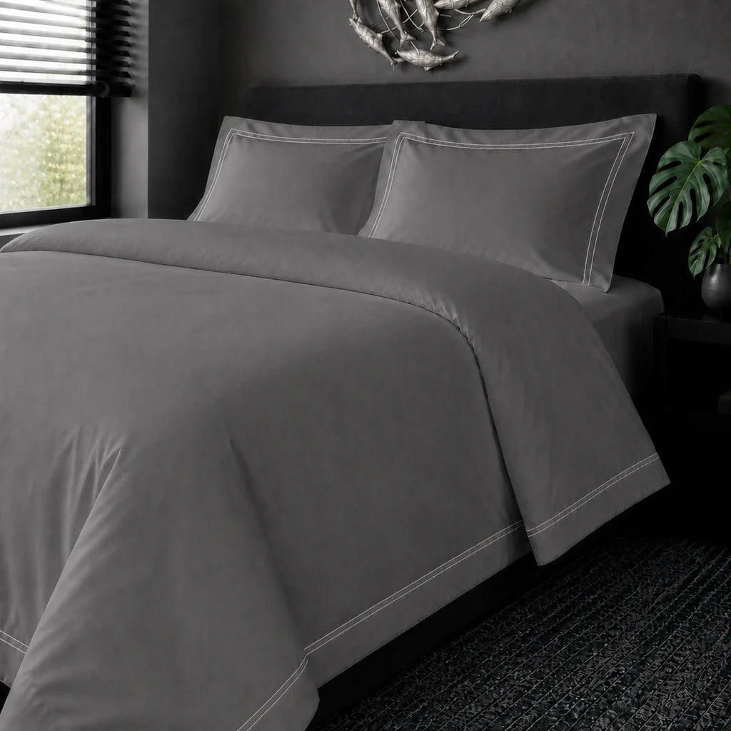 Grey cotton 200TC Oxford duvet cover set with white two-row satin stitch – on the bed view | Linen & Co