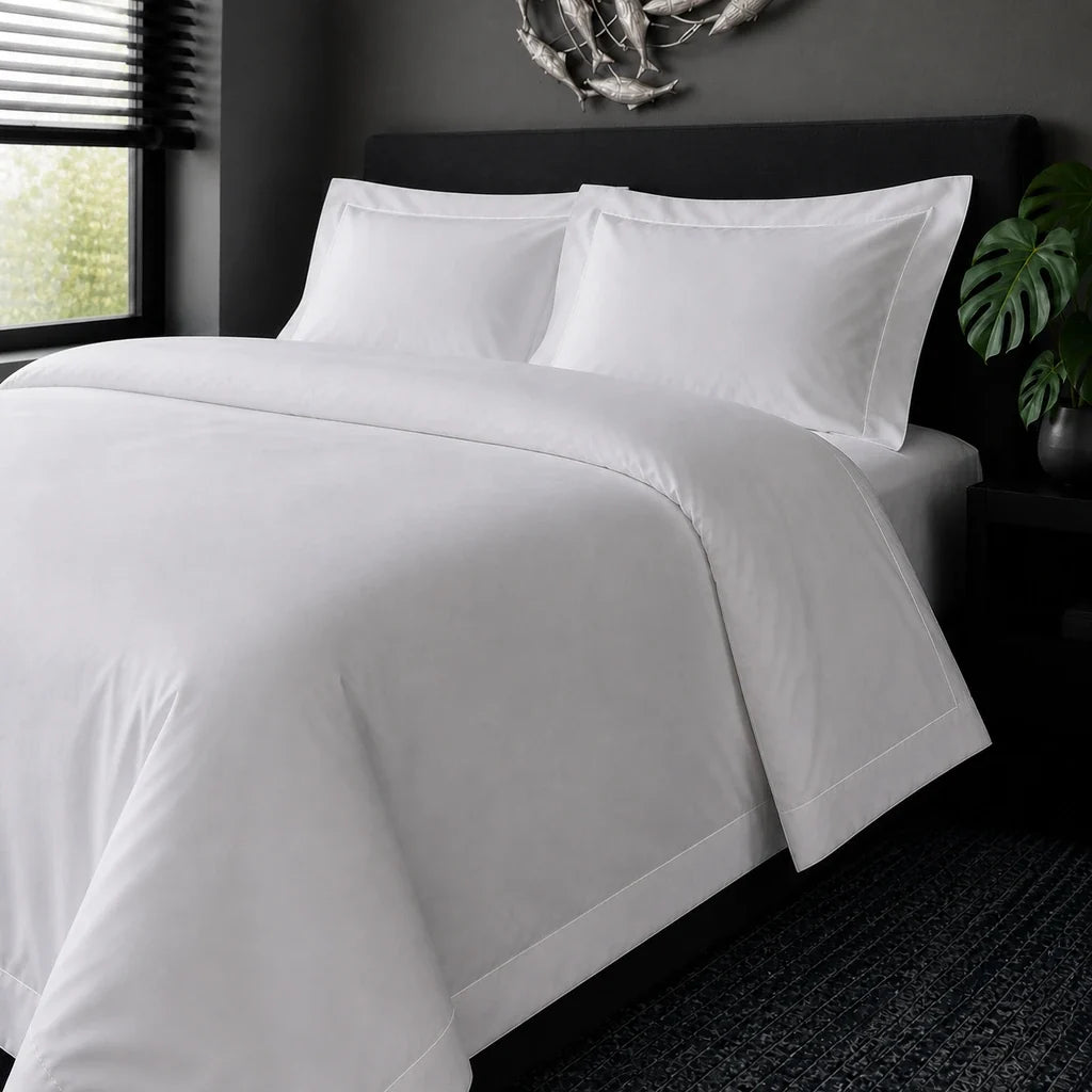White cotton 200TC Oxford duvet cover set with white one-row satin stitch – on-bed view | Linen & Co