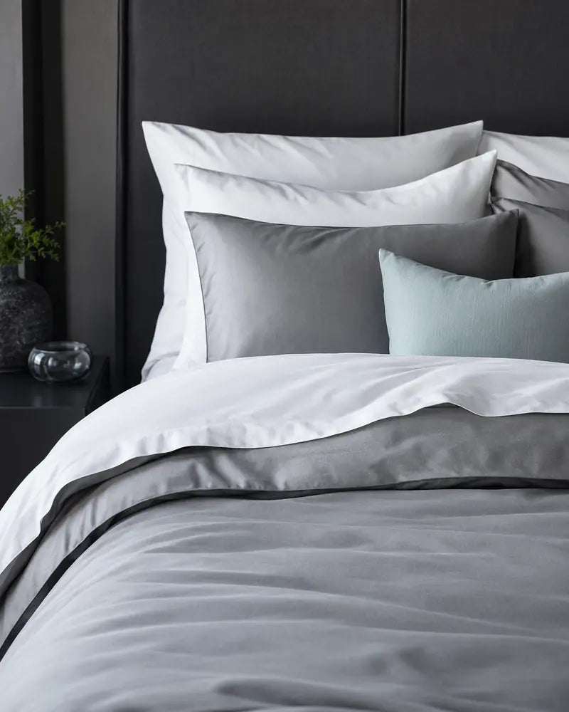 Layered grey and white duvet covers and sheets
