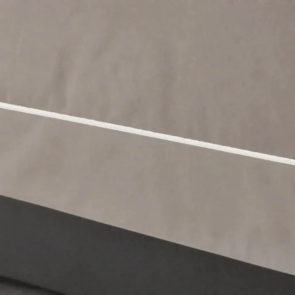 Close-up of the Stone Cotton 200TC Oxford duvet cover border with cream one-row satin stitch.