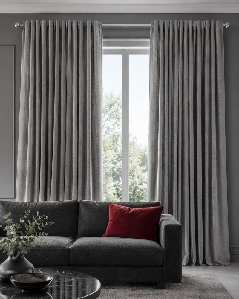 Grey ready-made curtains framing a modern lounge window