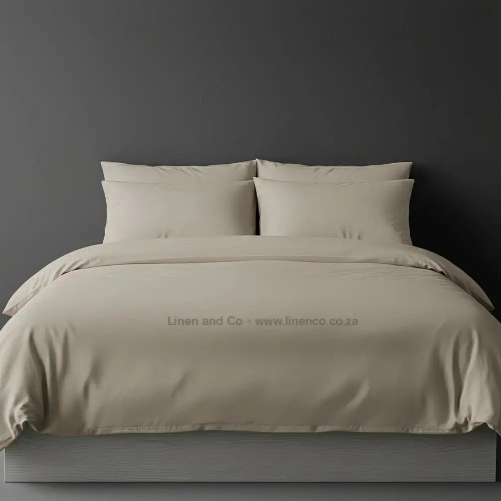 Stone percale duvet cover set from Linen and Co, showcasing pristine white bedding against a dark grey background, demonstrating clean and professional hospitality textile design