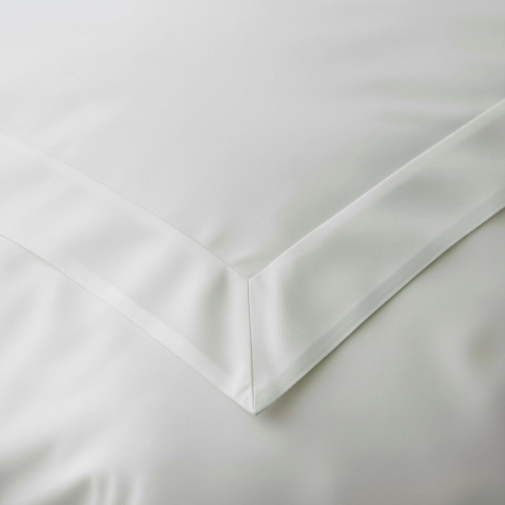 Close-up of white Oxford pillowcase corner border detail on premium cotton percale fabric by Linen and Co