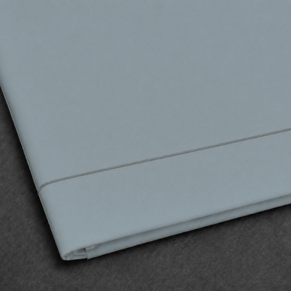 Duck Egg polycotton percale 200TC flat sheet with Stone one-row satin stitch — close-up detail.
