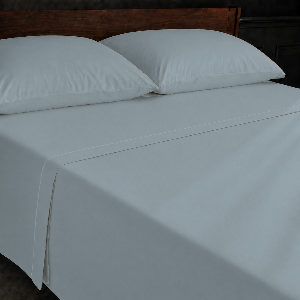Duck Egg polycotton percale 200TC flat sheet with White one-row satin stitch — on the bed.