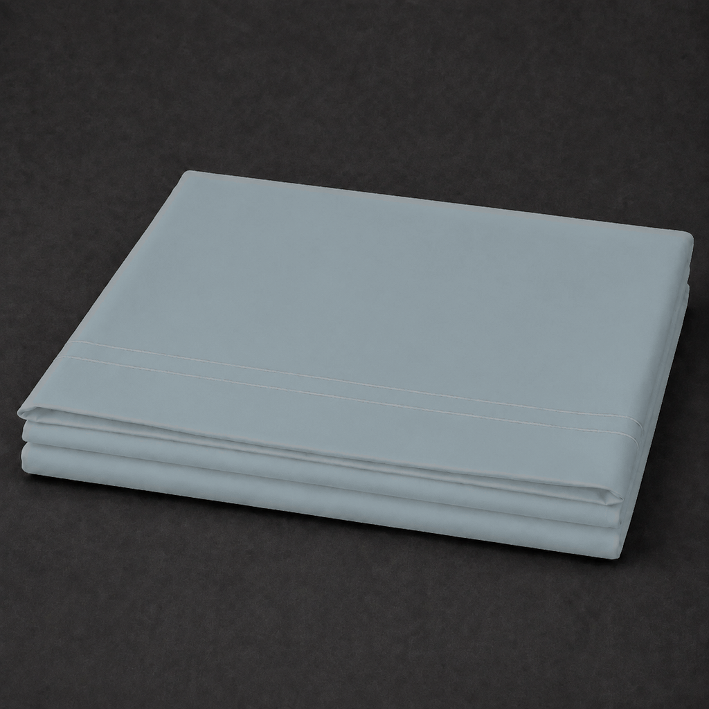 Duck Egg polycotton percale 200TC flat sheet with Natural Cream two-row satin stitch — on the bed.