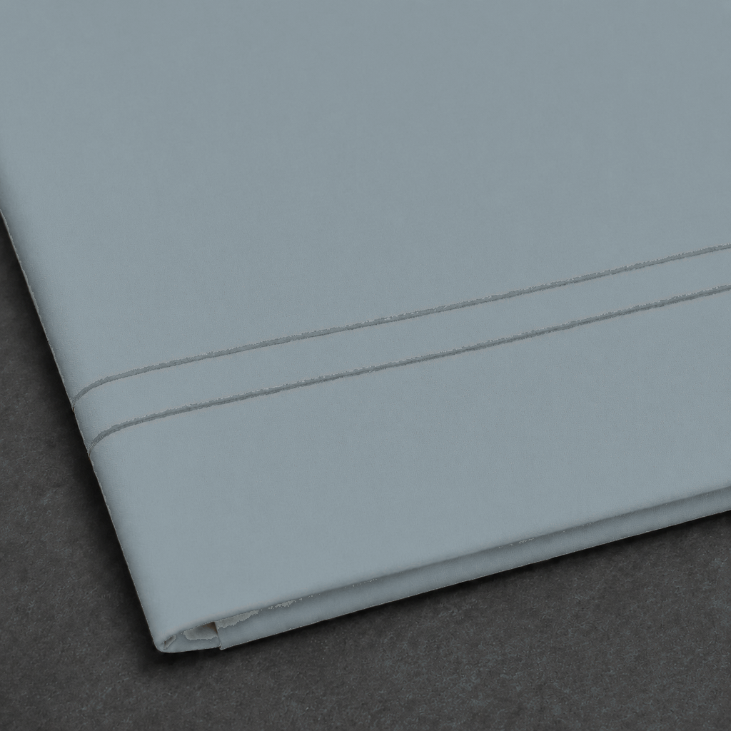 Duck Egg polycotton percale 200TC flat sheet with Stone two-row satin stitch — close-up detail.