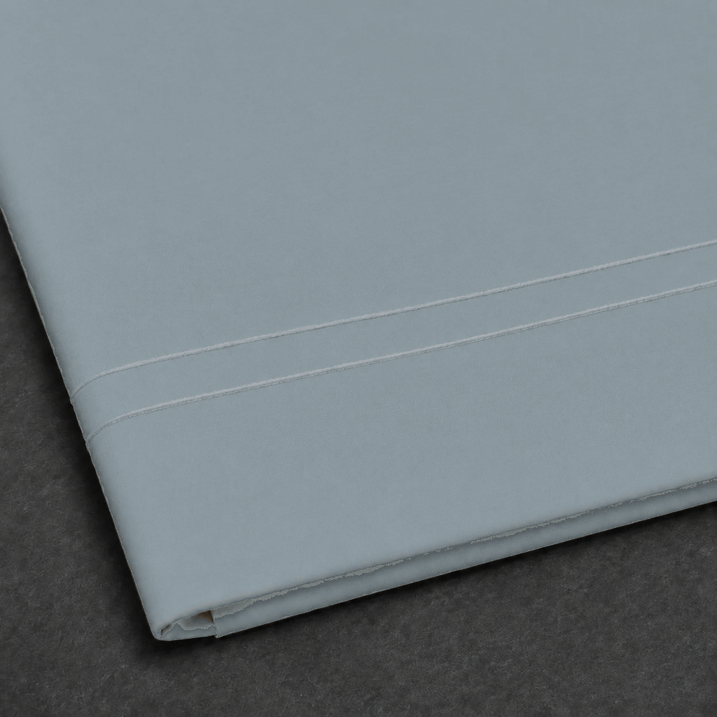 Duck Egg polycotton percale 200TC flat sheet with White two-row satin stitch — close-up detail.