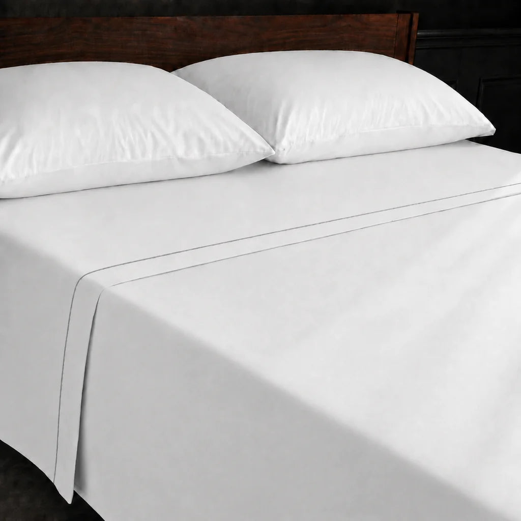 White Polycotton Percale 200TC flat sheet with Grey one row satin stitch - on the bed - Linen and Co