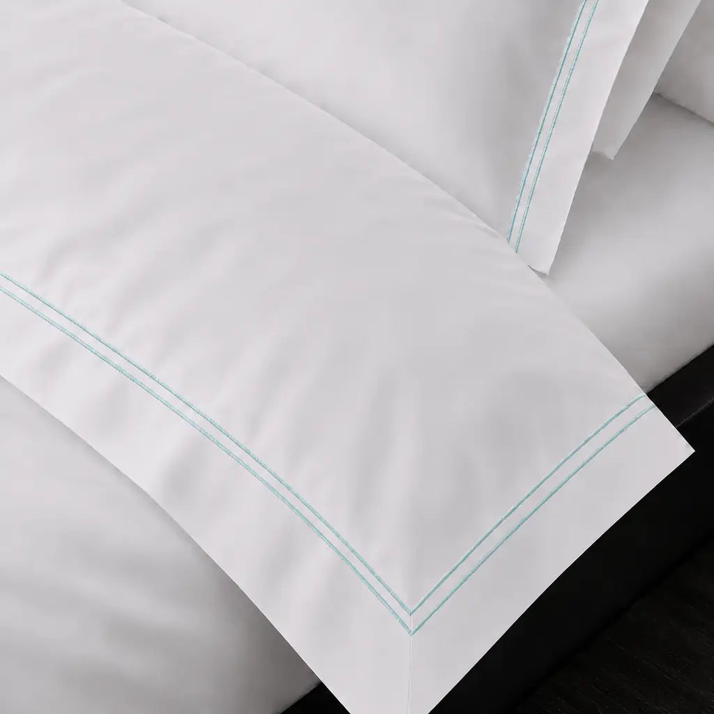 Cotton 300TC Oxford duvet cover set with two row duck egg satin stitch — on-bed detail — Linen & Co