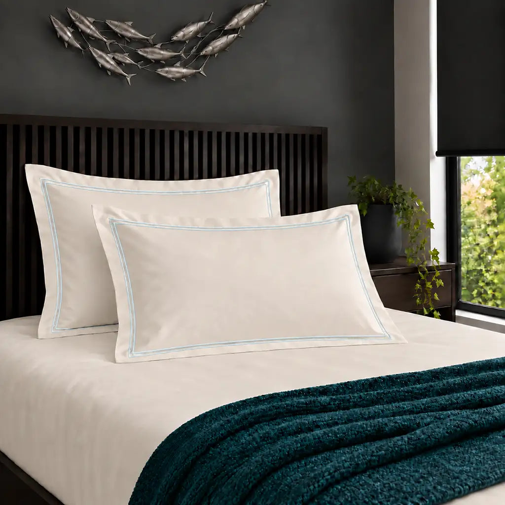 Oxford cream 200TC cotton percale pillowcases with two row duck egg satin stitch border by Linen and Co
