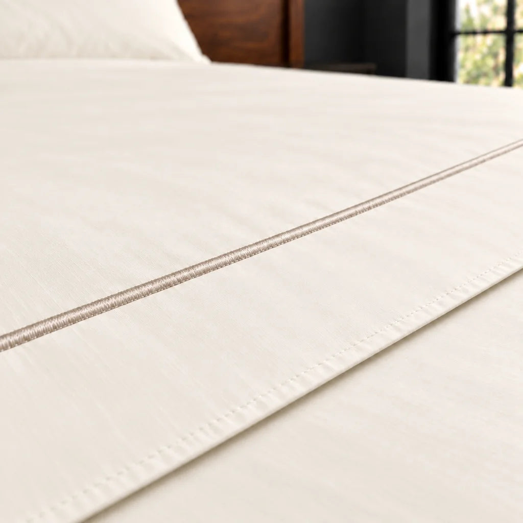 cream polycotton percale 200tc flat sheet, one row stone satin stitch — close up — Linen and Co