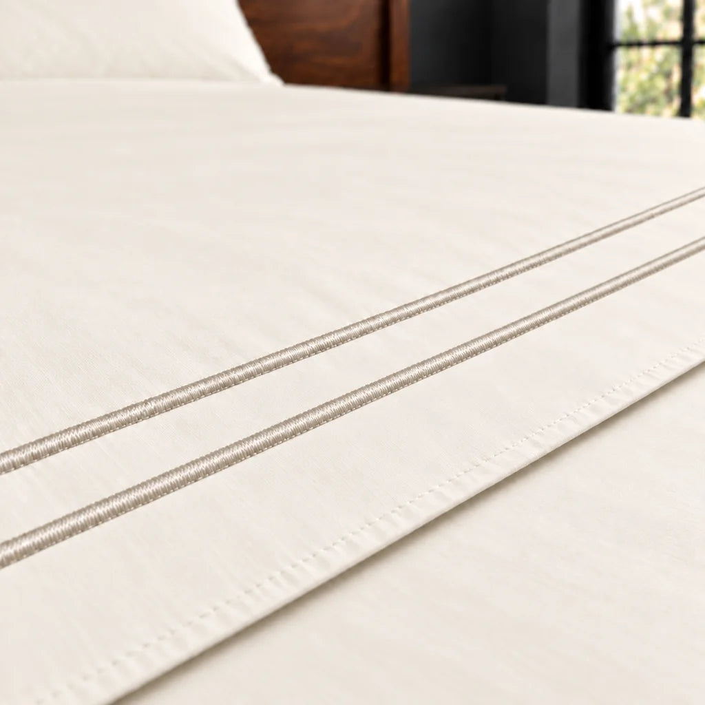 cream polycotton percale 200tc flat sheet, two row stone satin stitch — close up — Linen and Co
