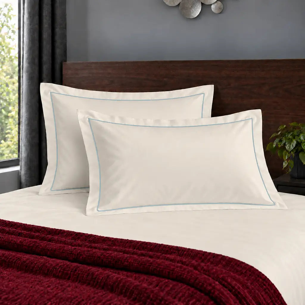 Oxford cream 200TC polycotton percale pillowcases with one row duck egg satin stitch border by Linen and Co