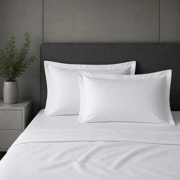 White 100% cotton percale 200TC Oxford pillow cases on a bed with no satin stitch.