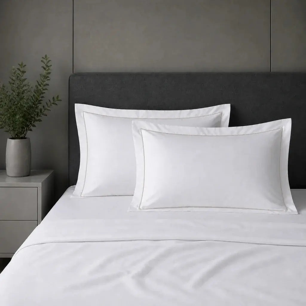 White 100% cotton percale 200TC Oxford pillow cases on a bed with Stone one-row satin stitch.
