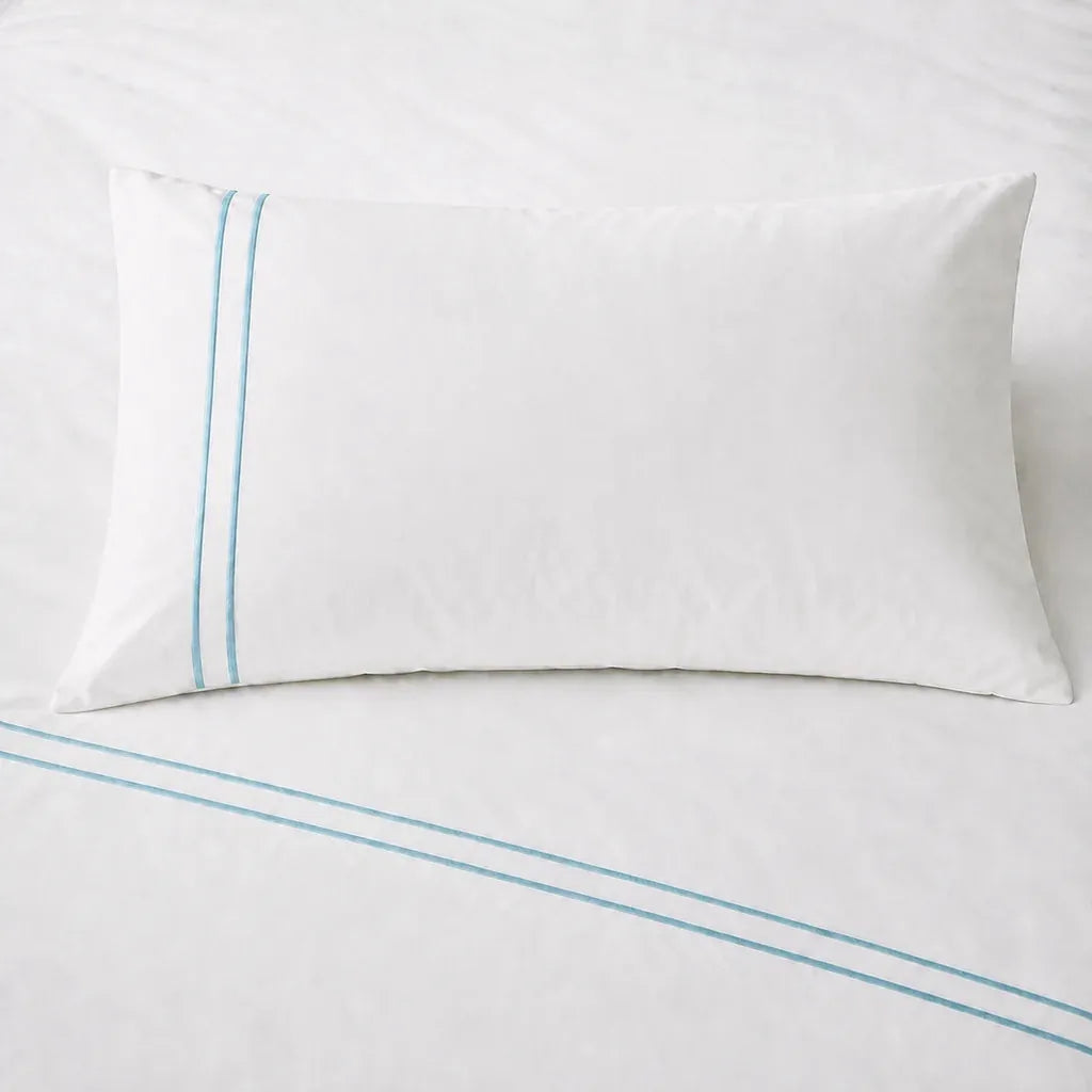 White 200TC plain duvet cover with Duck Egg two row satin stitch - on the bed - Linen and Co