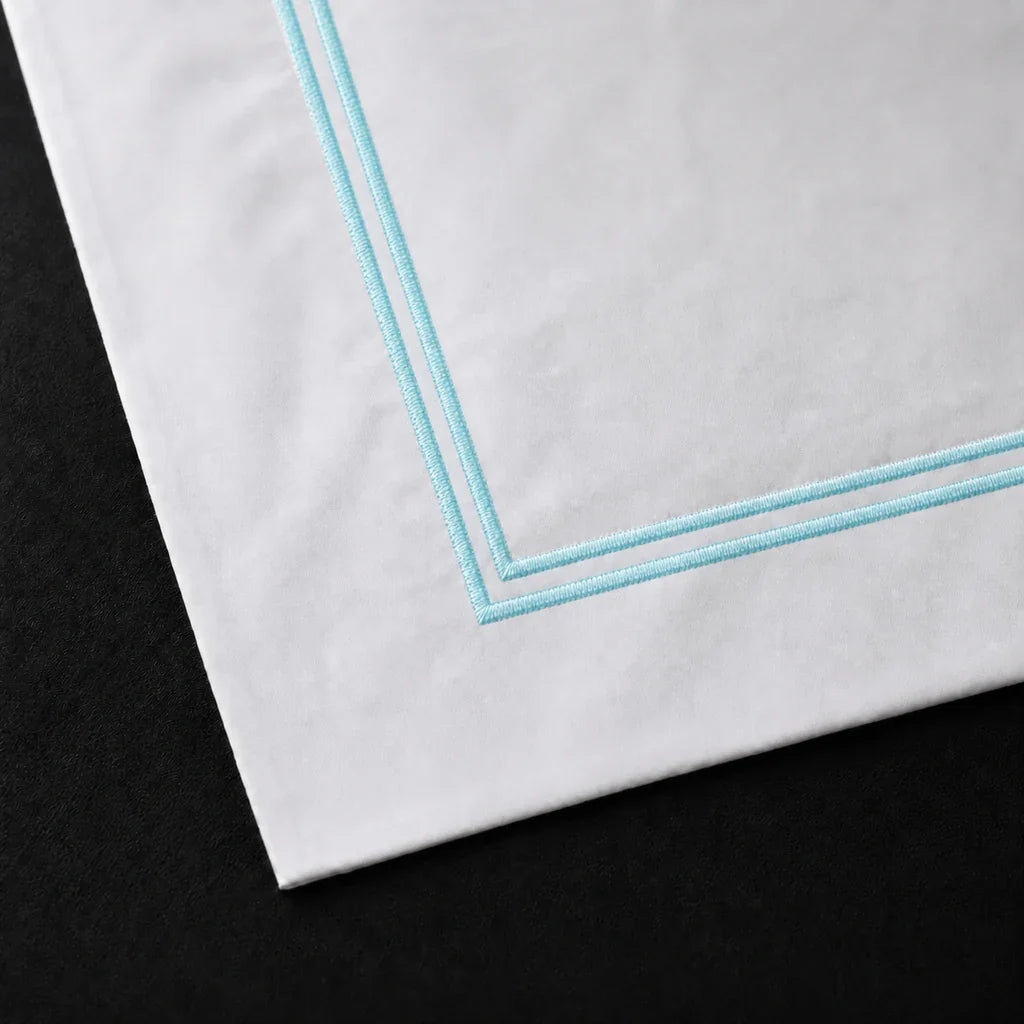 Close-up of a White 100% cotton percale 300TC Oxford pillow case with Duck Egg two-row satin stitch.