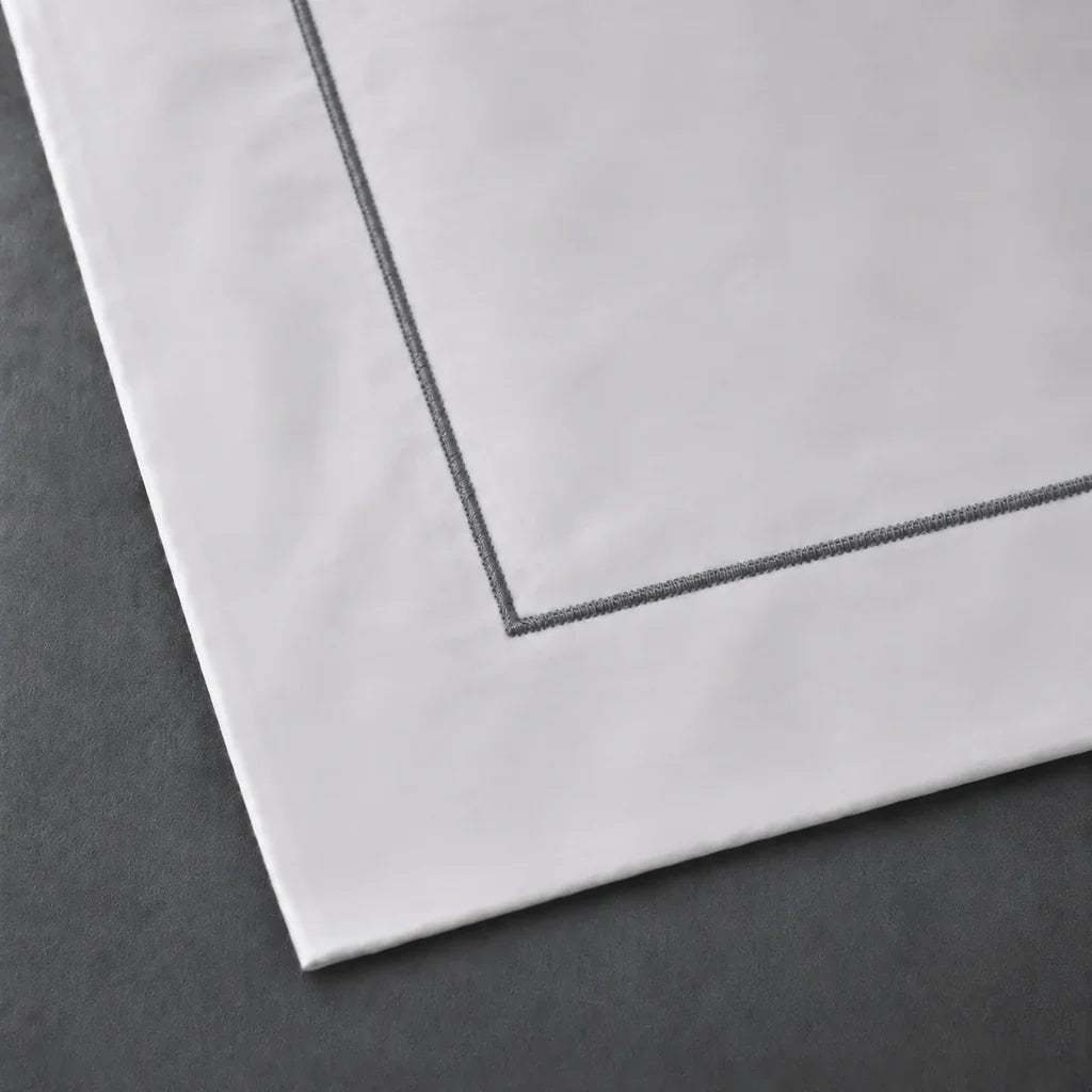 Close-up of a White 100% cotton percale 300TC Oxford pillow case with Grey one-row satin stitch.