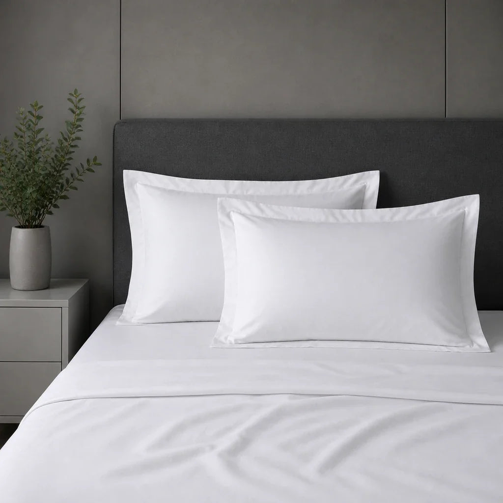 White 100% cotton percale 300TC Oxford pillow cases on a bed with no satin stitch.