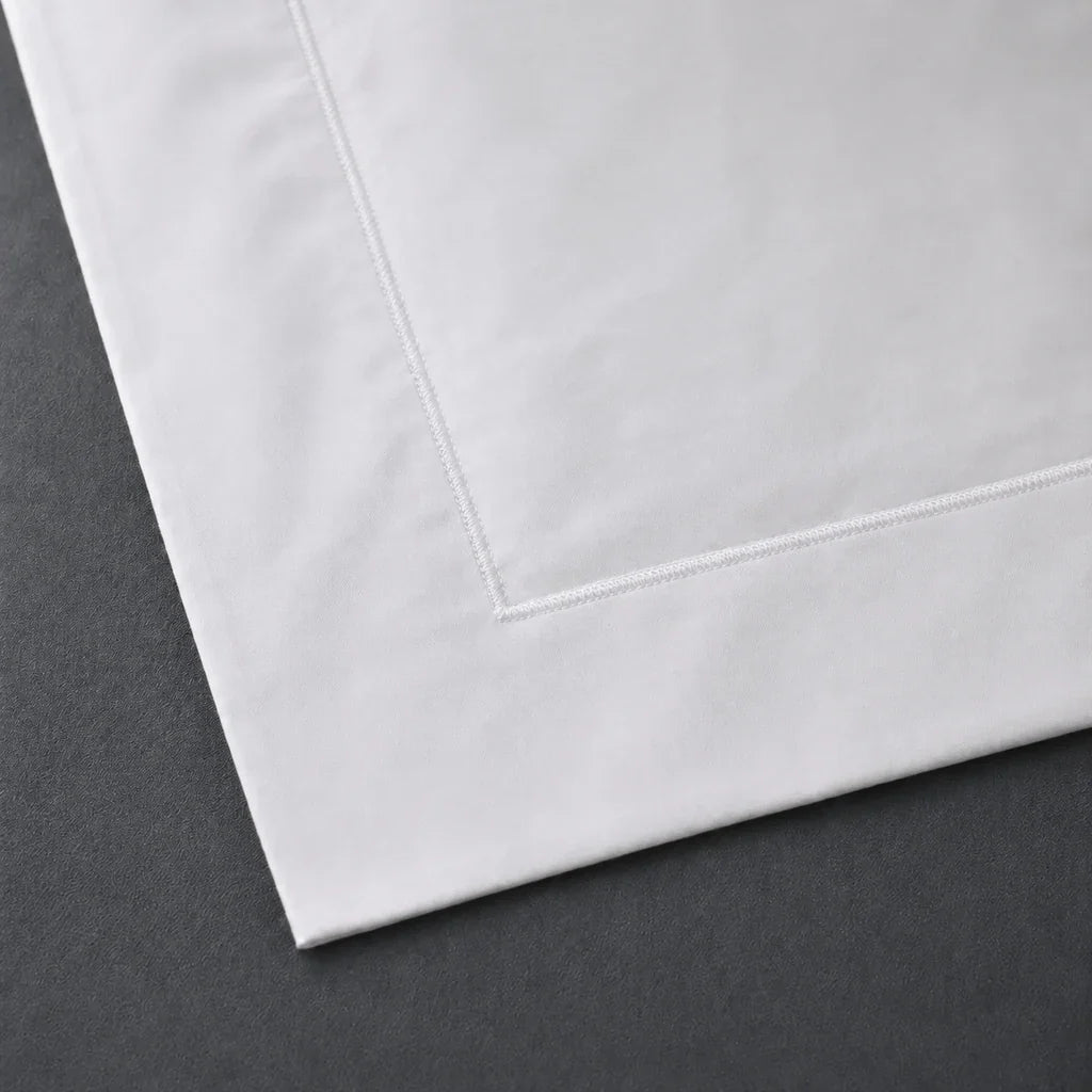 Close-up of a White 100% cotton percale 300TC Oxford pillow case with White one-row satin stitch.