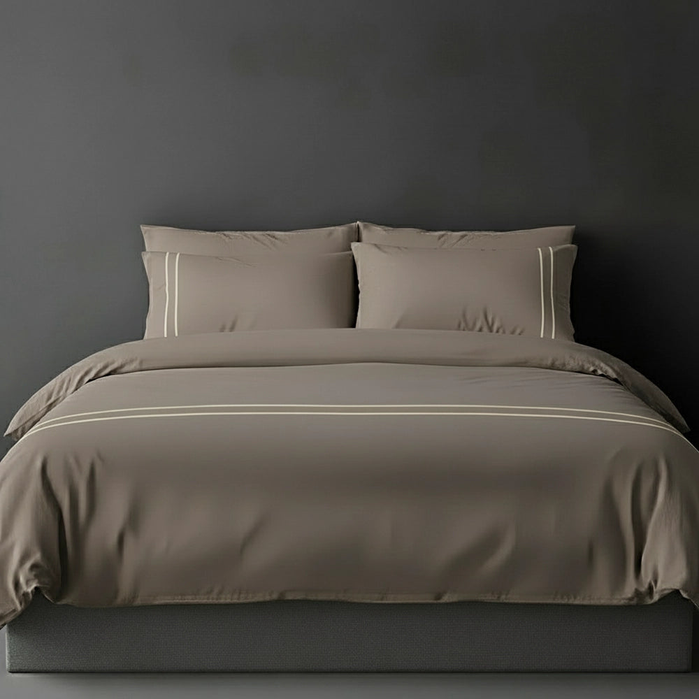 Stone duvet cover with cream satin stitch and pillows by Linen and Co - luxury bed linen