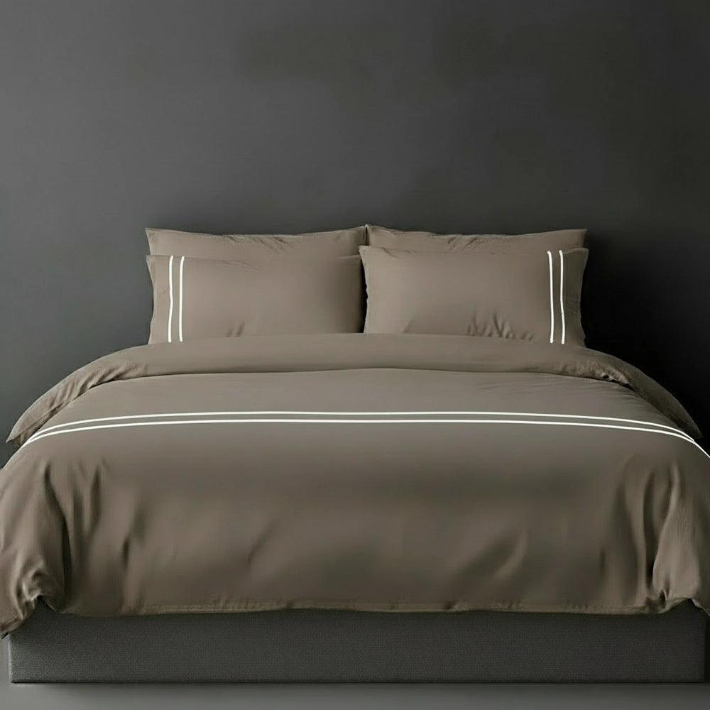 Stone duvet cover with white satin stitch and pillows by Linen and Co - luxury bed linen