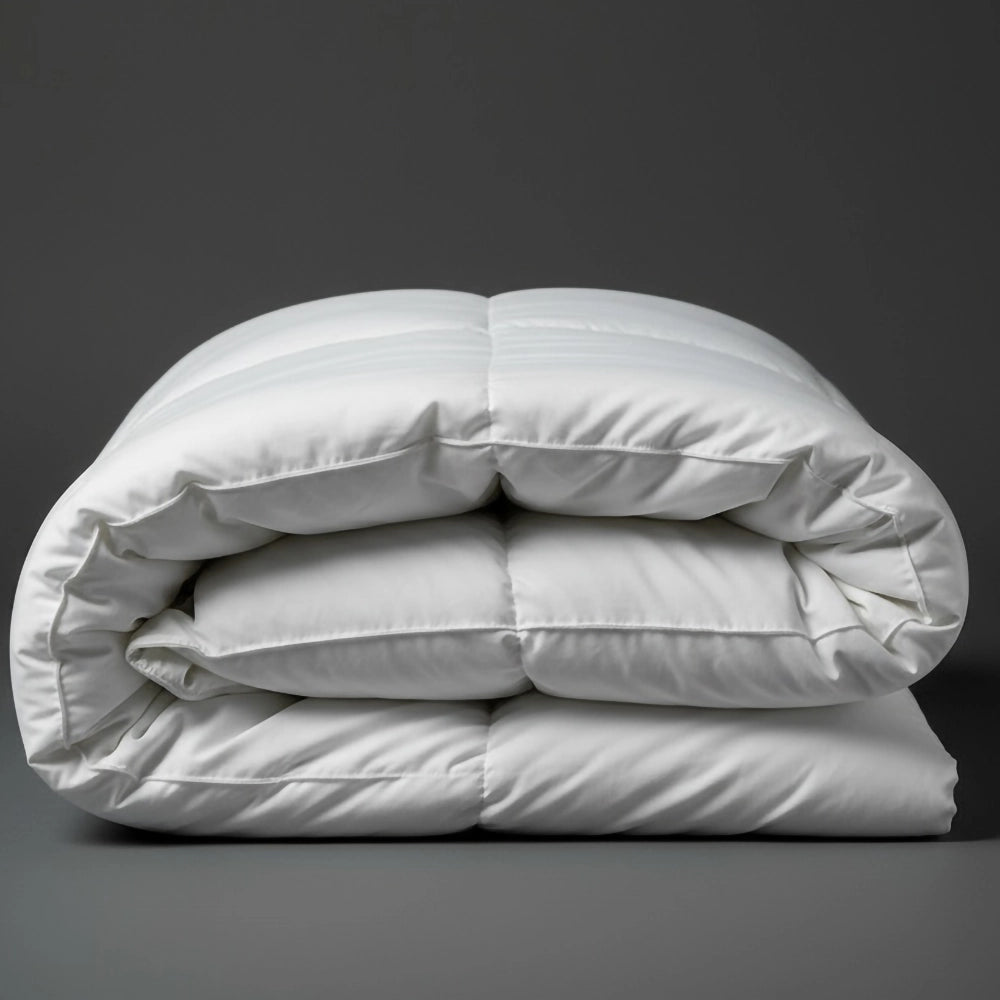 Folded white luxury microfibre duvet inner on dark grey background—soft, hypoallergenic duvet comforter by Linen & Co