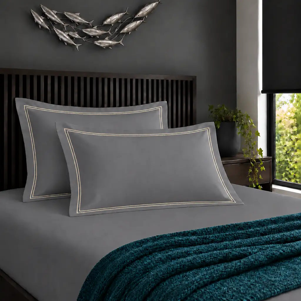 Oxford grey 200TC cotton percale pillowcases with two row cream satin stitch border by Linen and Co