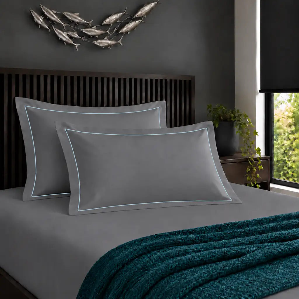 Oxford grey 200TC cotton percale pillowcases with one row duck egg satin stitch border by Linen and Co