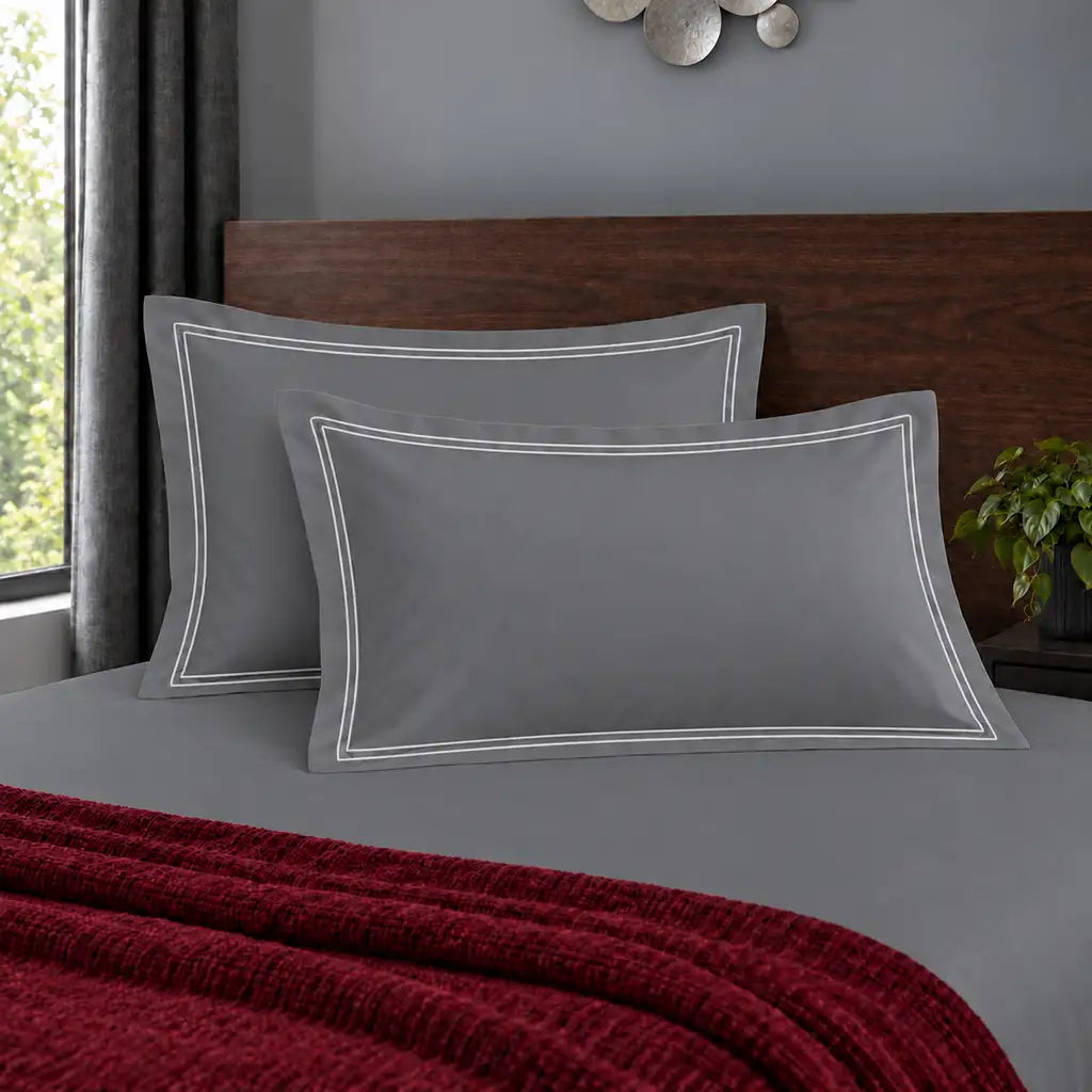 Oxford grey 200TC polycotton percale pillowcases with two row white satin stitch border by Linen and Co