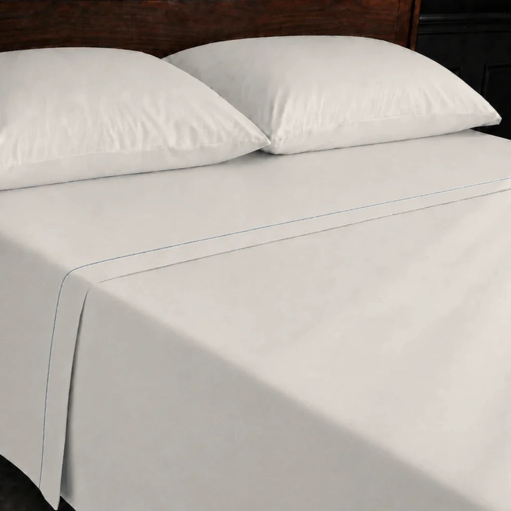 Ivory Cream 100% Cotton Percale 200TC flat sheet with Grey one-row satin stitch - on the bed - Linen and Co