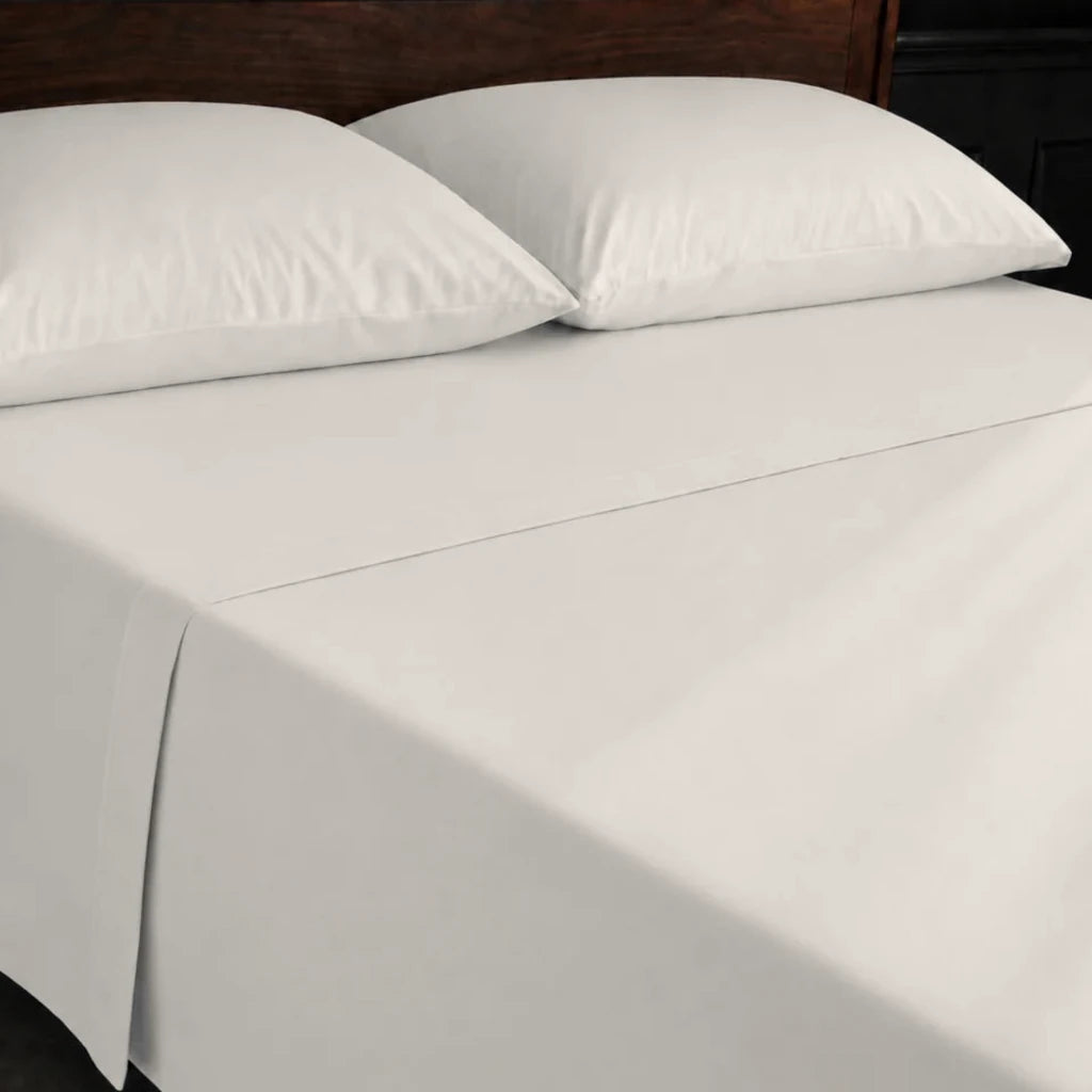 Ivory Cream 100% Cotton Percale 200TC flat sheet with no satin stitch - on the bed - Linen and Co