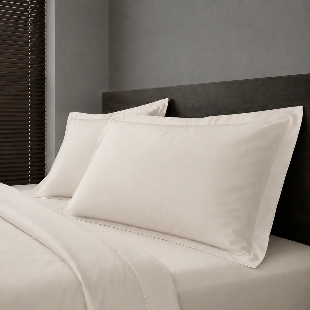 Ivory Cream Polycotton Percale 200TC Oxford pillow cases on a bed with no satin stitch - Linen and Co