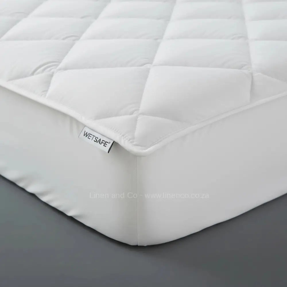 White towelling Wetsafe mattress protector with terry texture and brand label - Linen and Co