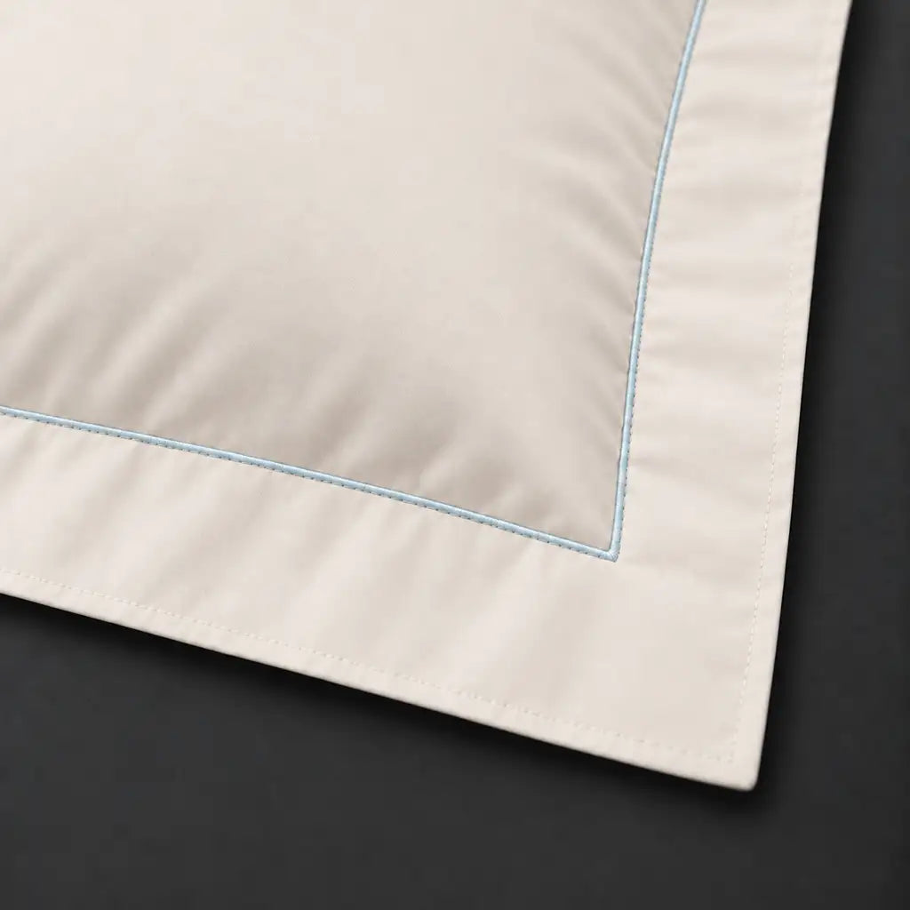 Close-up of cream Oxford pillowcase with one row duck egg satin stitch border by Linen and Co