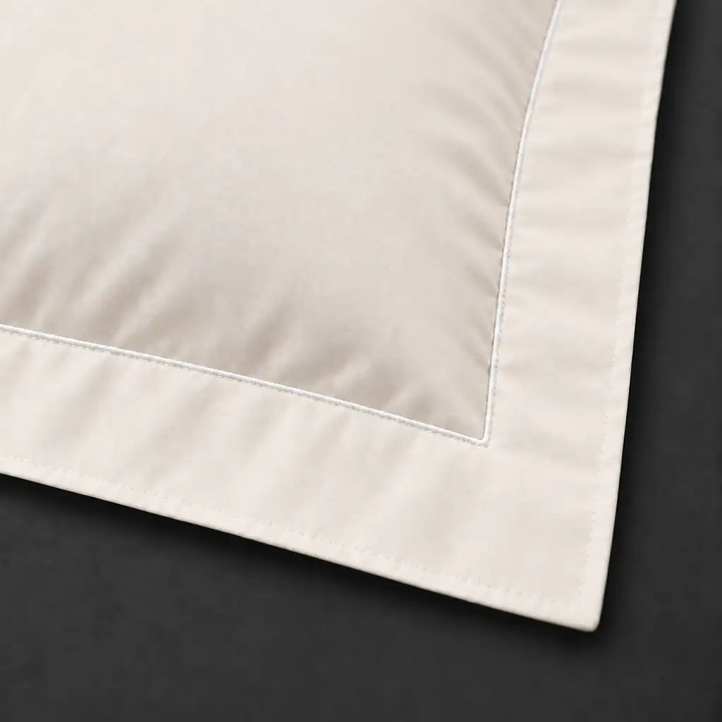 Close-up of cream Oxford pillowcase with one row white satin stitch border by Linen and Co