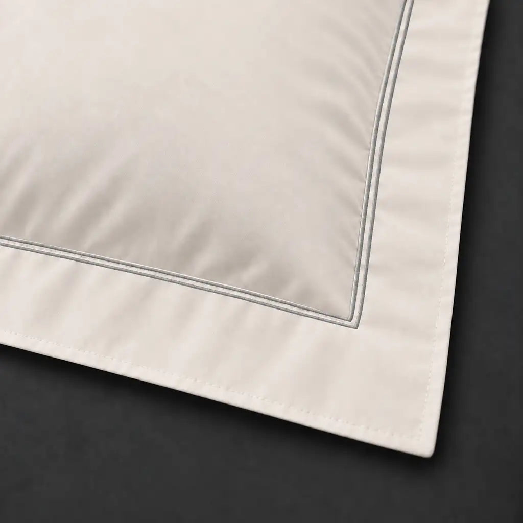 Close-up of cream Oxford pillowcase with two row grey satin stitch border by Linen and Co