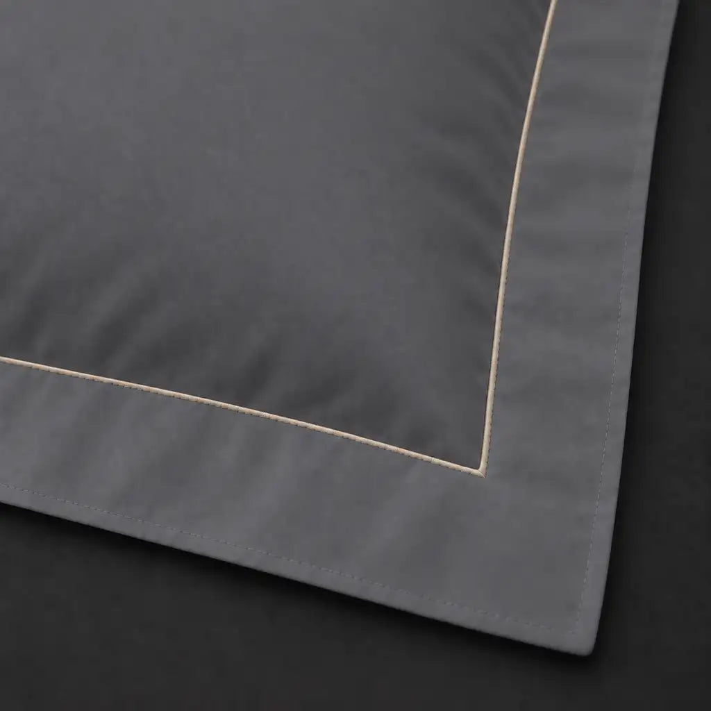 Close-up of grey Oxford pillowcase with one row cream satin stitch border by Linen and Co