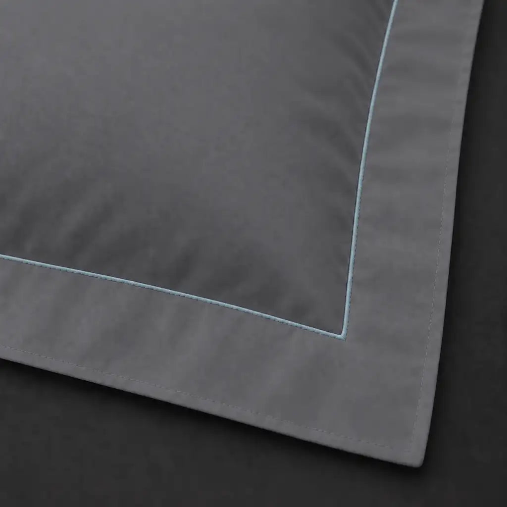 Close-up of grey Oxford pillowcase with one row duck egg satin stitch border by Linen and Co