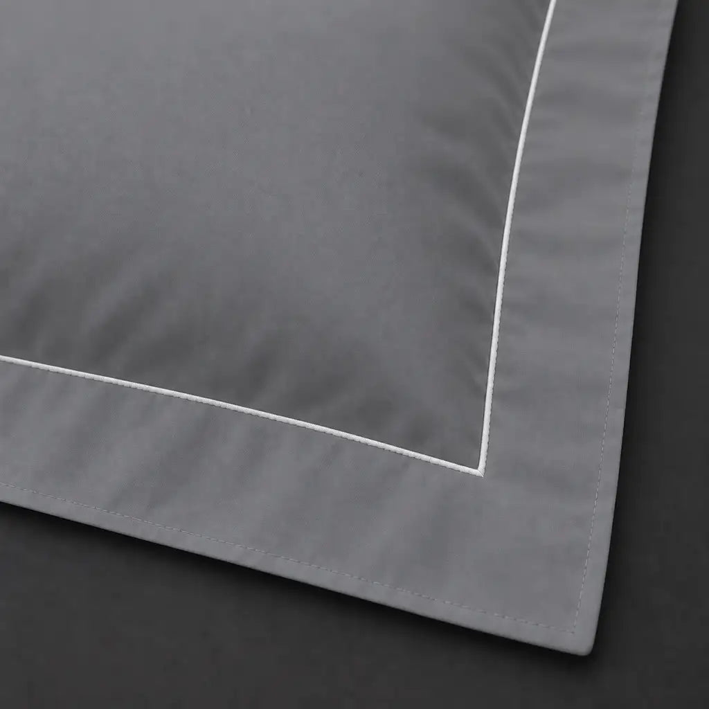 Close-up of grey Oxford pillowcase with one row white satin stitch border by Linen and Co
