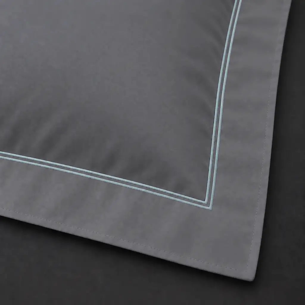 Close-up of grey Oxford pillowcase with two row duck egg satin stitch border by Linen and Co