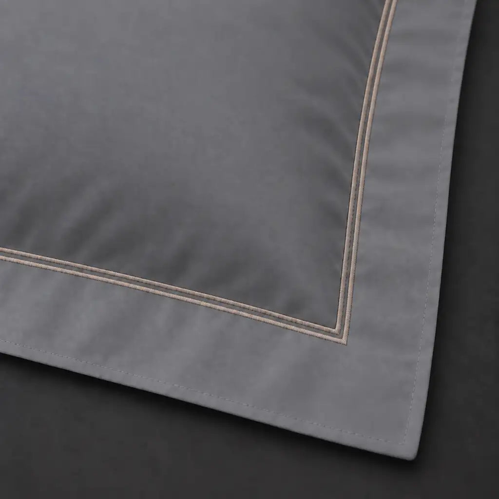 Close-up of grey Oxford pillowcase with two row grey satin stitch border by Linen and Co