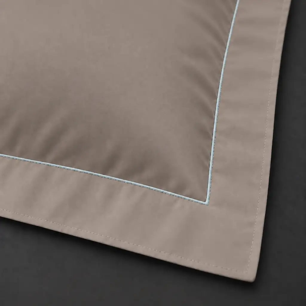 Close-up of stone Oxford pillowcase with one row duck egg satin stitch border by Linen and Co
