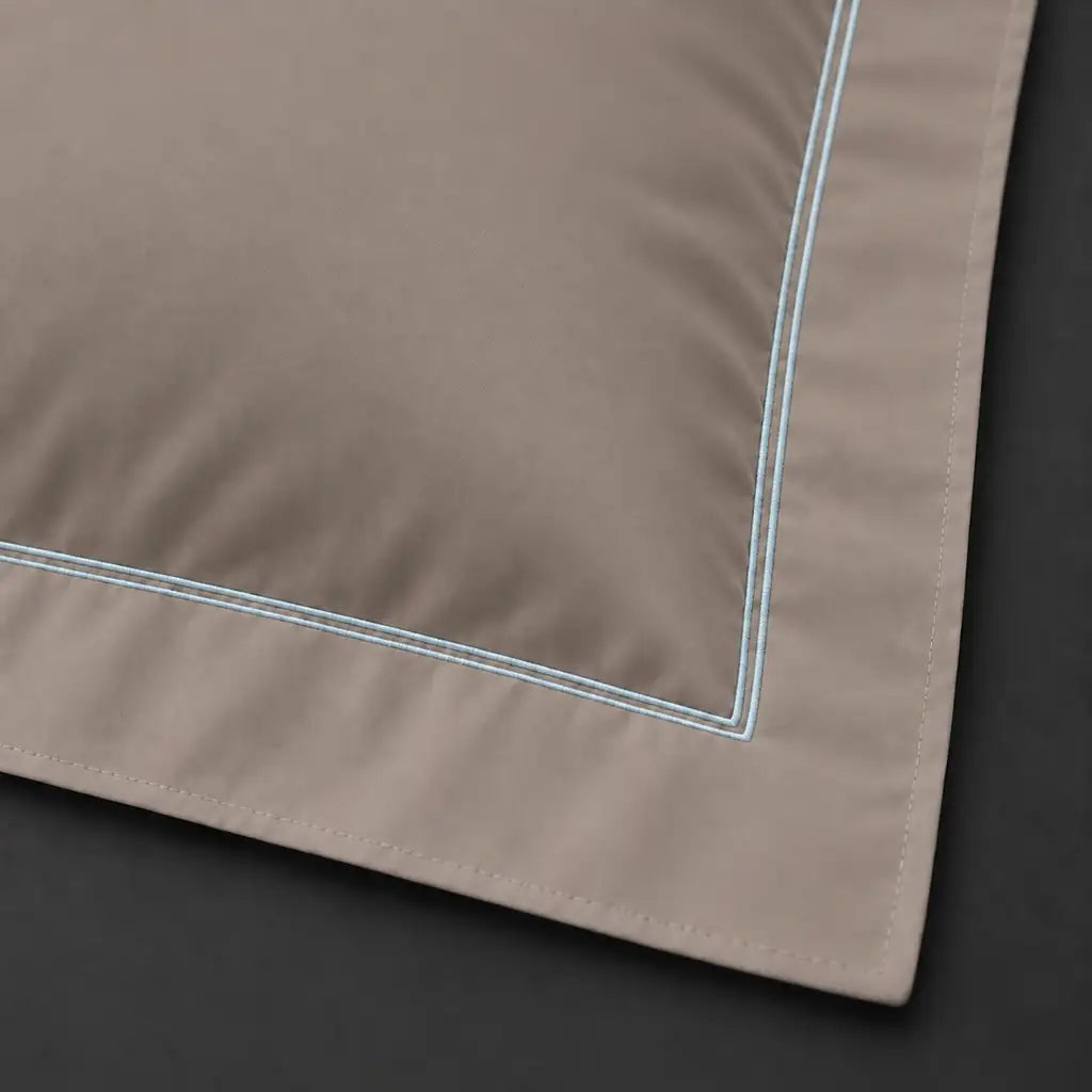 Close-up of stone Oxford pillowcase with two row duck egg satin stitch border by Linen and Co