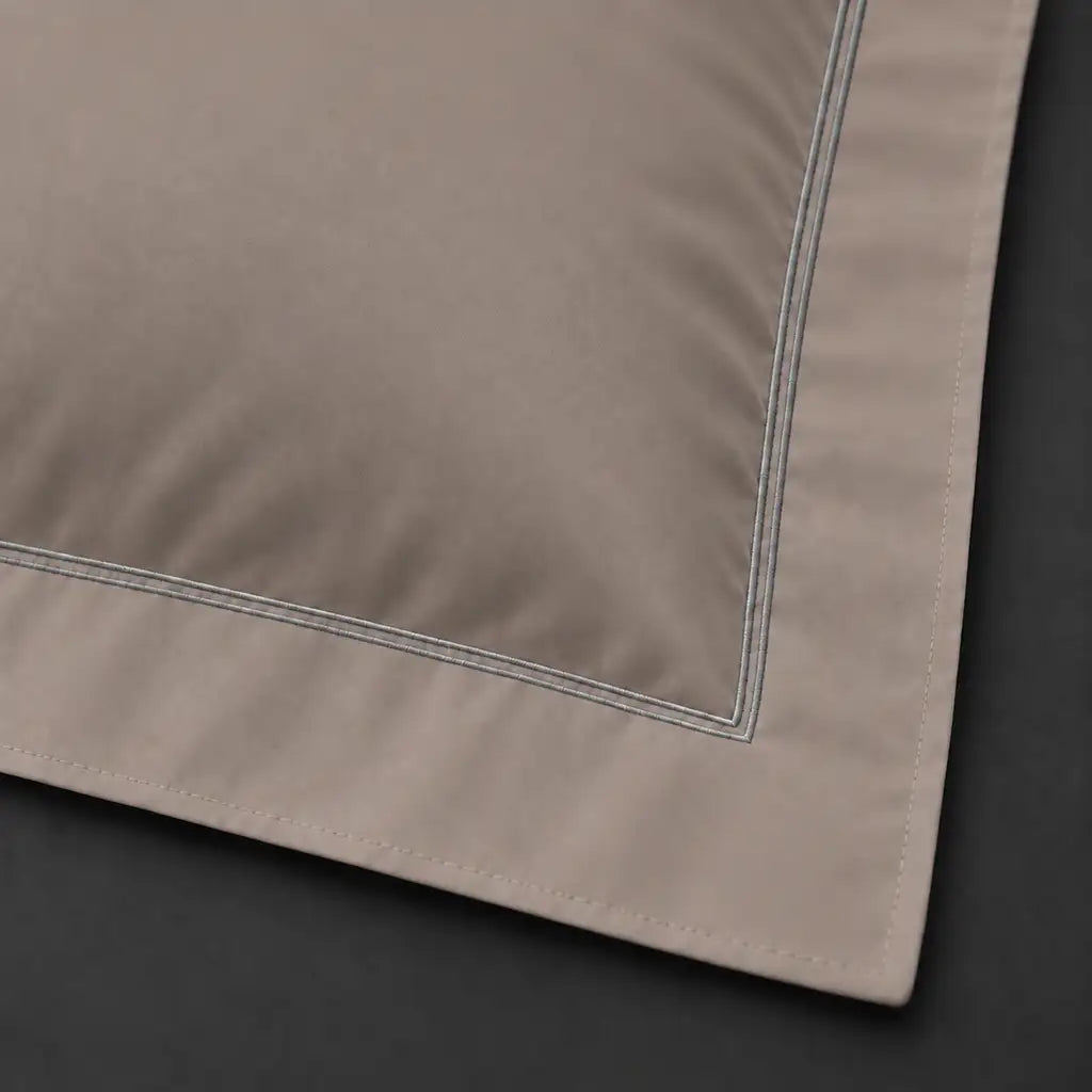 Close-up of stone Oxford pillowcase with two row grey satin stitch border by Linen and Co