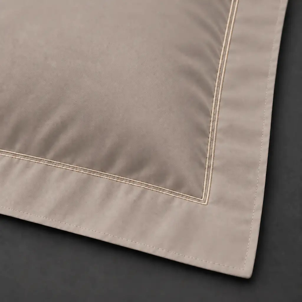 Close-up of stone Oxford pillowcase with two row stone satin stitch border by Linen and Co