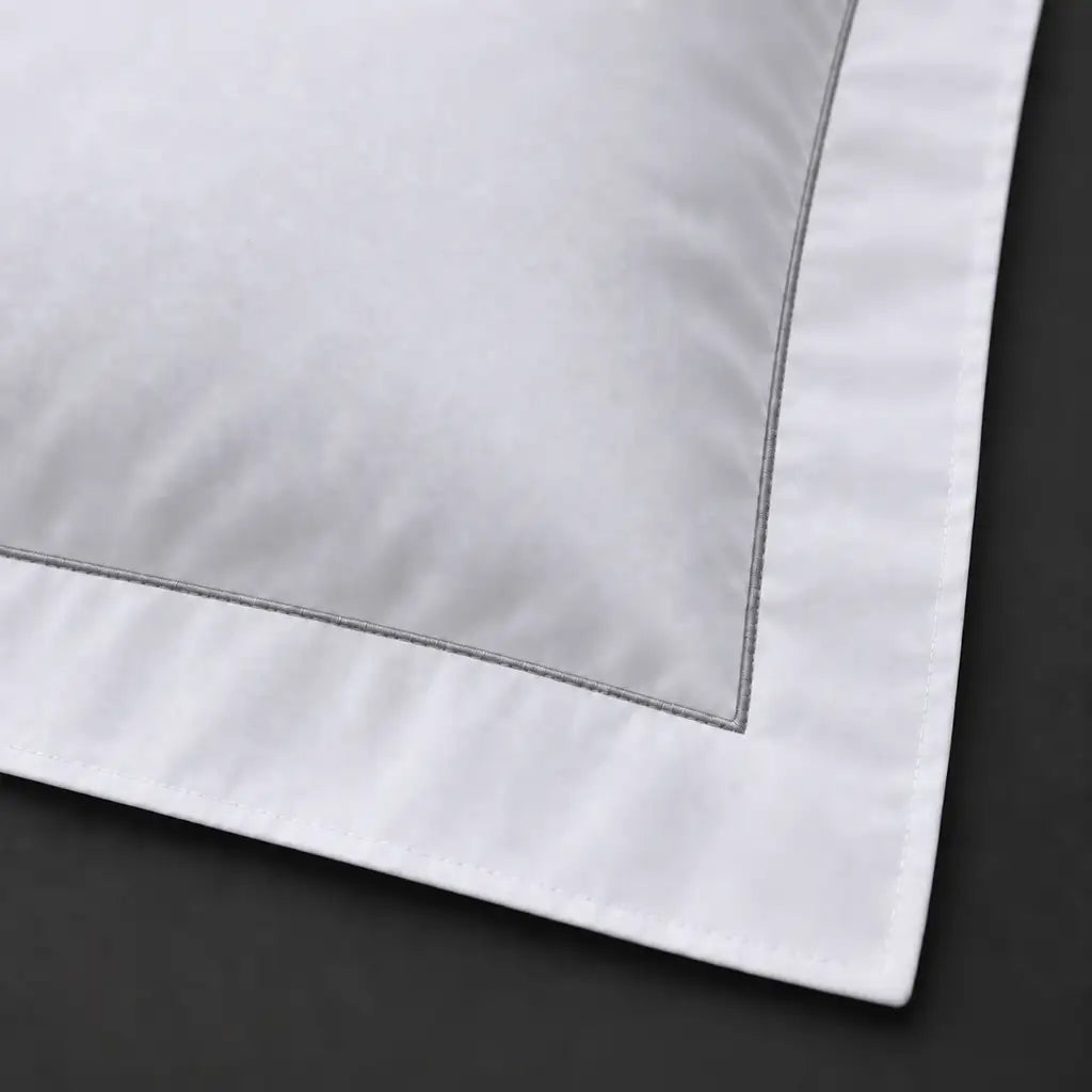 Close-up of white Oxford pillowcase with one row grey satin stitch border by Linen and Co